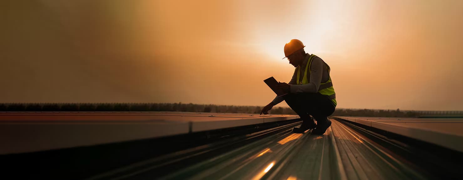 Solar panel worker at sunset